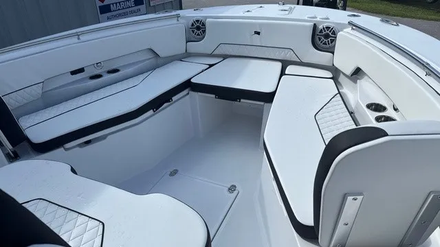 Slide: The Image of The image shows the cockpit of a 2027 Stingray 253 CC boat with white upholstery. - 9