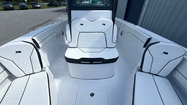 Slide: The Image of The image shows the cockpit of a 2027 Stingray 253 CC boat with white, cushioned seating. - 10
