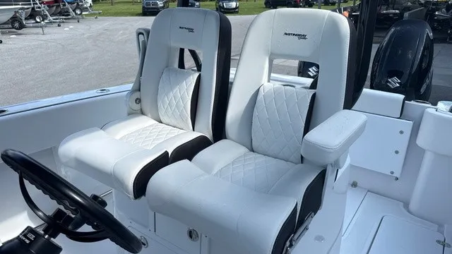 Slide: The Image of Two luxurious, cushioned seats with white and black accents on a boat. - 13
