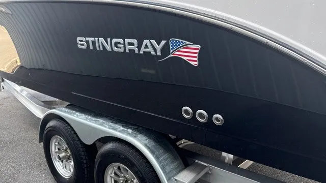 Slide: The Image of A black boat with "Stingray" and an American flag on a trailer. - 5