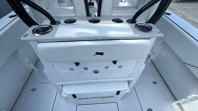 Slide: The Image of The image shows the cockpit of a Stingray 253 CC boat with cup holders and storage. - 15