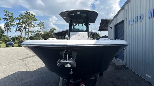Slide: The Image of Stingray 253 CC 2027: A modern boat with sleek design, parked in front of a building. - 6