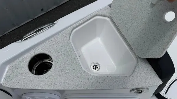 Slide: The Image of The image shows a sink with a cover and a cup holder on a boat. - 8