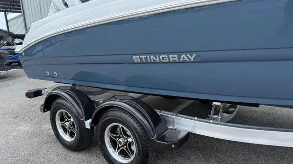 Slide: The Image of A blue Stingray 206 CC boat hull on a trailer with dual axles. - 2