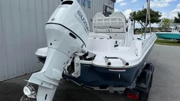 Slide: The Image of A modern 2027 Stingray 206 CC with a Suzuki outboard motor, parked on a trailer. - 5