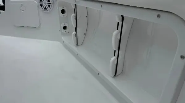 Slide: The Image of Interior view of a boat with white storage compartments and speakers. - 15