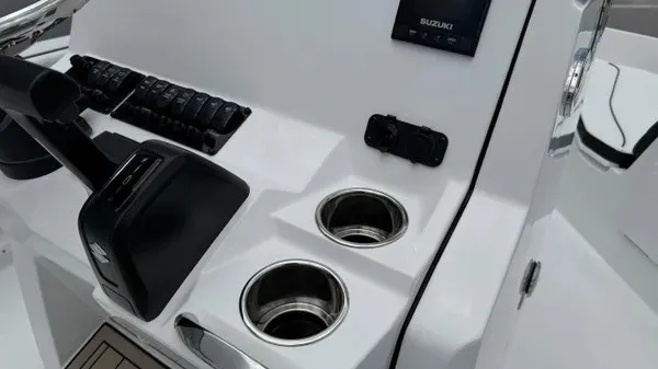 Slide: The Image of The image shows a boat's helm with cup holders and controls. - 18