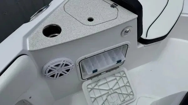 Slide: The Image of The image shows the cockpit of a Stingray 206 CC boat with storage and a speaker. - 9