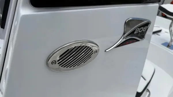 Slide: The Image of Close-up of a speaker and model badge on a white boat. - 16