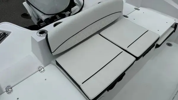 Slide: The Image of The 2027 Stingray 206 CC features a white bench seat with black accents and a motor in the background. - 22