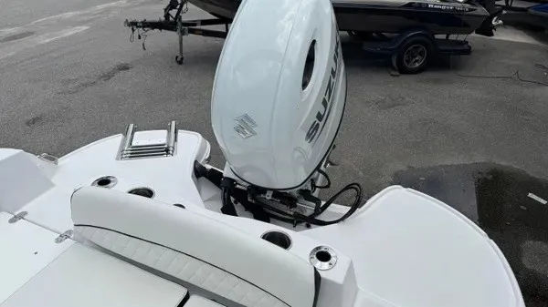 Slide: The Image of The image shows the stern of a Stingray 206 CC boat with a Suzuki outboard motor. - 13