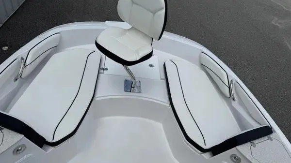 Slide: The Image of The image shows the bow of a Stingray 206 CC boat with white cushions and a seat. - 7