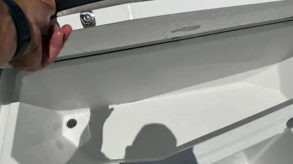 Slide: The Image of Close-up of a white boat compartment with a drain and shadow. - 27