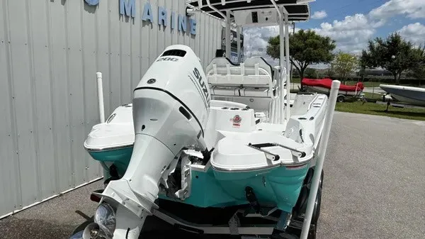 Slide: The Image of A 2027 Stingray 216 CC boat with an outboard motor, parked on a trailer. - 5