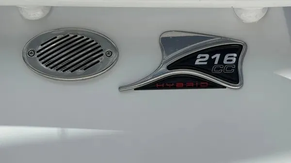 Slide: The Image of Close-up of a boat emblem reading "216 CC Hybrid" next to a speaker grille. - 3
