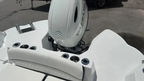 Slide: The Image of The image shows the stern of a Stingray 216 CC boat with a Suzuki outboard motor. - 21