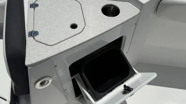Slide: The Image of The image shows a gray boat console with a round cup holder and an open storage compartment. - 24