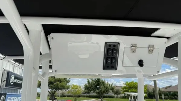 Slide: The Image of The image shows a boat's helm console with switches and a latch. - 14