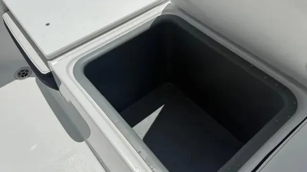 Slide: The Image of An open storage compartment on a boat, surrounded by white surfaces. - 20