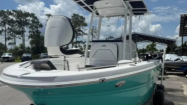 Slide: The Image of A modern 2027 Stingray 216 CC with a turquoise hull and white upper deck. - 8