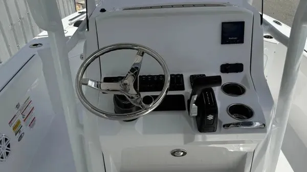 Slide: The Image of The image shows the helm of a Stingray 216 CC boat with a modern steering wheel and instruments. - 13