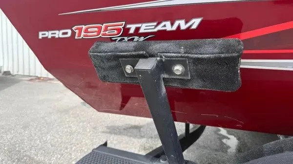 Slide: The Image of Close-up of a red Tracker Pro Team 195 TXW Tournament Edition boat with a black mount. - 3