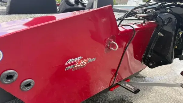 Slide: The Image of Close-up of a red boat hull with a motor and cables. - 7