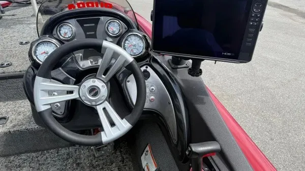 Slide: The Image of The image shows the cockpit of a 2023 Tracker Pro Team 195 TXW Tournament Edition boat. It features a modern steering wheel and a large display. - 15