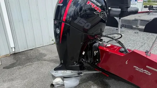 Slide: The Image of A red Tracker Pro Team 195 TXW Tournament Edition boat with a Mercury 150 HP outboard motor. - 4