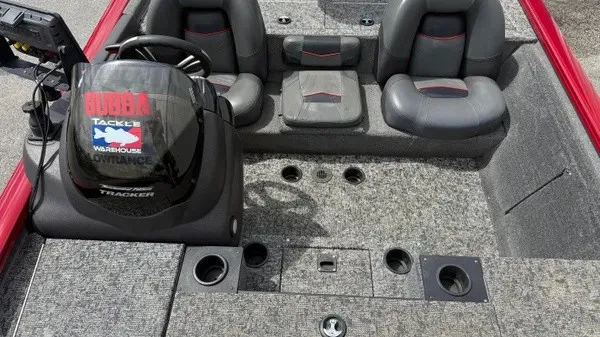 Slide: The Image of The image shows the cockpit of a 2023 Tracker Pro Team 195 TXW Tournament Edition boat with gray seats. - 14