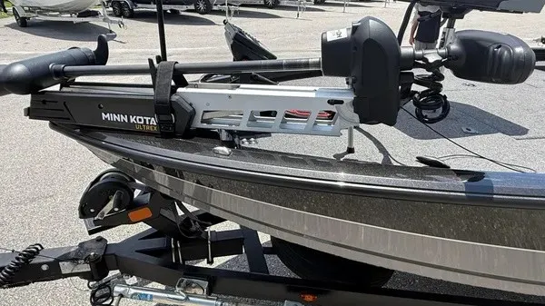 Slide: The Image of A 2019 Vexus AVX 2080 boat with a Minn Kota trolling motor, parked on a trailer. - 7