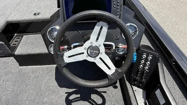 Slide: The Image of The image shows the cockpit of a 2019 Vexus AVX 2080 boat with a modern steering wheel and instruments. - 11