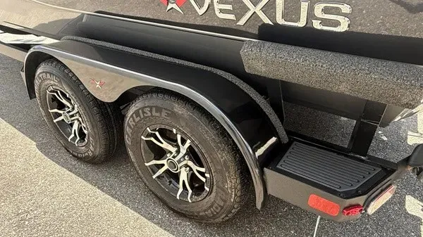 Slide: The Image of Close-up of a 2019 Vexus AVX 2080 boat trailer with stylish black wheels. - 5