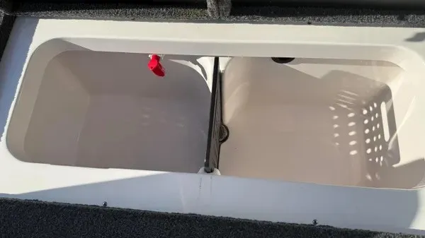 Slide: The Image of The image shows an open storage compartment on a 2024 Vexus AVX 1980 boat. - 21