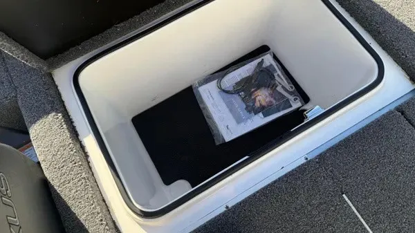 Slide: The Image of An open storage compartment on a Vexus AVX 1980 boat, featuring gray carpeted flooring. - 23
