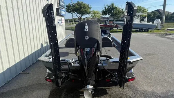 Slide: The Image of A 2024 Vexus AVX 1980 boat with a 150 HP motor, parked on an asphalt lot. - 4