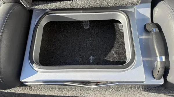 Slide: The Image of An open storage compartment on a Vexus AVX 1980 boat, surrounded by cushioned seating. - 19