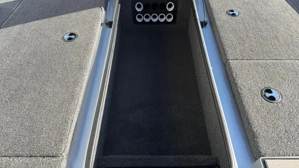 Slide: The Image of The image shows the interior of a 2024 Vexus AVX 1980 boat with storage and rod holders. - 17