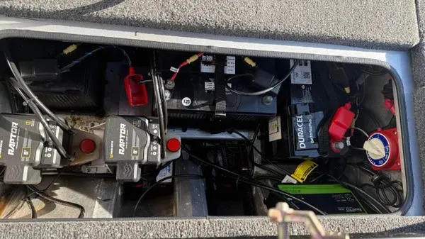 Slide: The Image of View of a Vexus AVX 1980 boat's battery compartment with multiple batteries and wiring. - 10