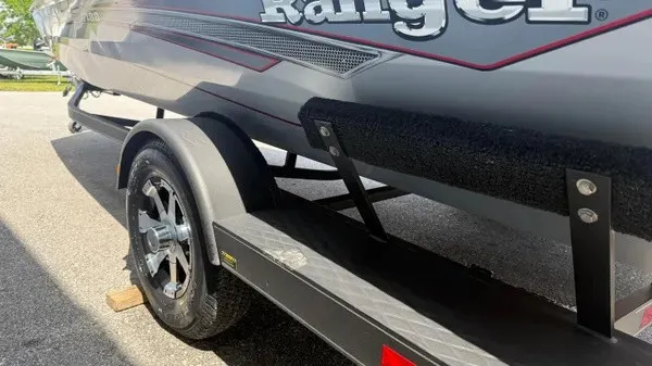 Slide: The Image of A 2018 Ranger RT188 boat on a trailer, featuring a sturdy wheel and padded support. - 5