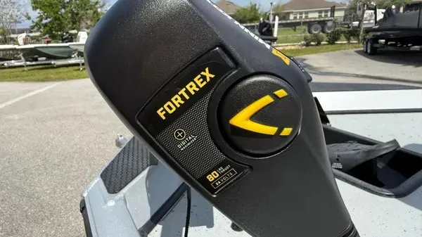 Slide: The Image of Close-up of a Fortrex motor on a Ranger boat, parked outdoors. - 8