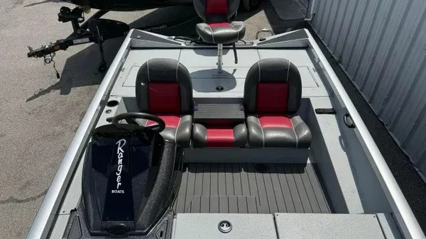 Slide: The Image of The image shows a 2018 Ranger RT188 boat with gray and red seating. - 10