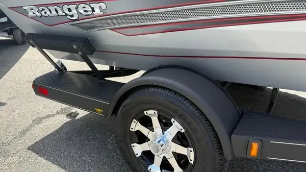 Slide: The Image of Close-up of a Ranger RT188 boat trailer with stylish rims and gray body. - 3