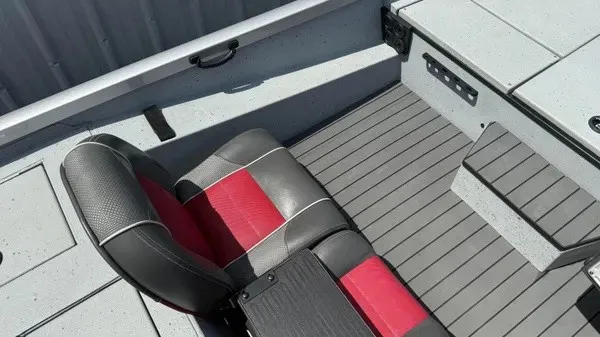Slide: The Image of The image shows the interior of a 2018 Ranger RT188 boat with a gray floor and a black-red seat. - 13