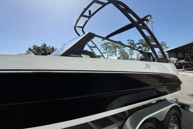 Slide: The Image of A modern 2027 Stingray 20 SBX with sleek design and black hull on a trailer. - 6