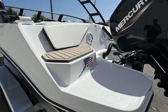 Slide: The Image of The image shows the stern of a Stingray 20 SBX boat with a Mercury outboard motor. - 23
