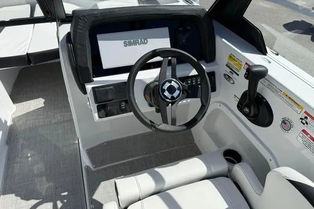 Slide: The Image of The image shows the cockpit of a 2027 Stingray 20 SBX boat with a Simrad display. - 9