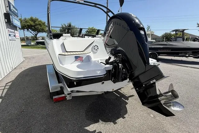 Slide: The Image of A 2027 Stingray 20 SBX boat on a trailer, featuring an outboard motor and an American flag. - 22
