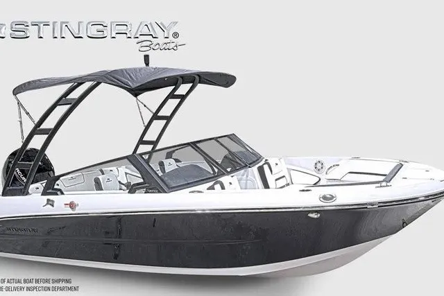 Slide: The Image of The image shows a modern 2027 Stingray 20 SBX boat with a sleek black hull and a Bimini top. - 31