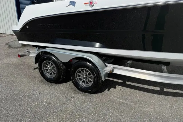 Slide: The Image of A Stingray 20 SBX boat on a dual-axle trailer, ready for transport. - 4